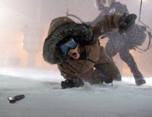 Kate Beckinsale, as U.S. Marshal Carrie Stetko, in the bitter cold frantically reaching for a gun